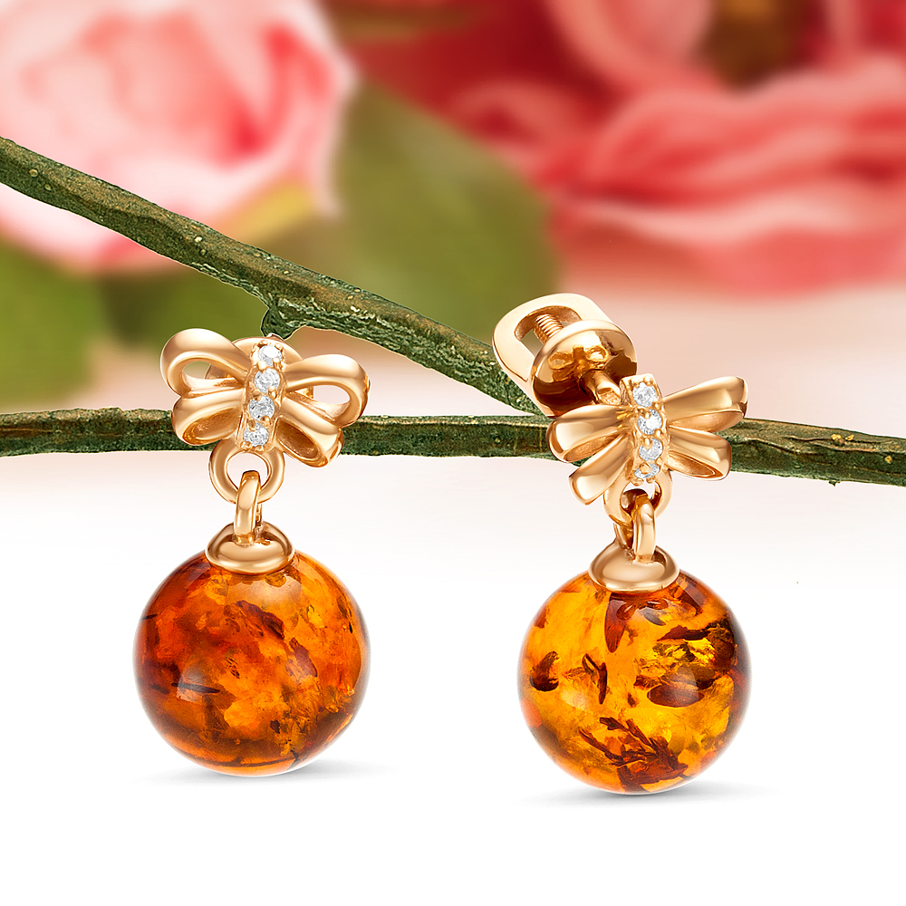 Серьги "Бантики" из серебра 925 пробы, украшенные коньячным янтарем, артикул 11257